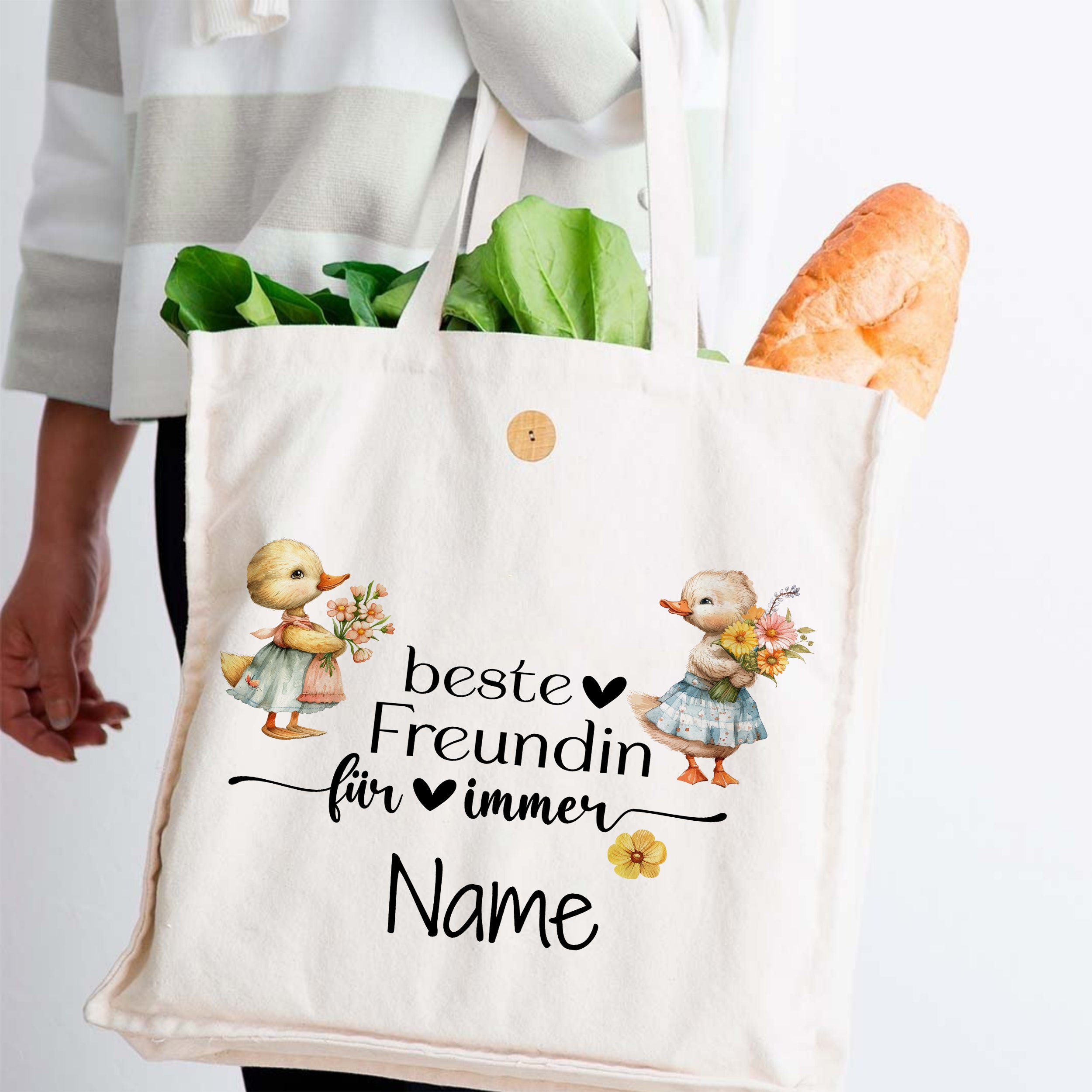 Beige Baumwolltasche mit Entenmotiven und persönlichem Namen.