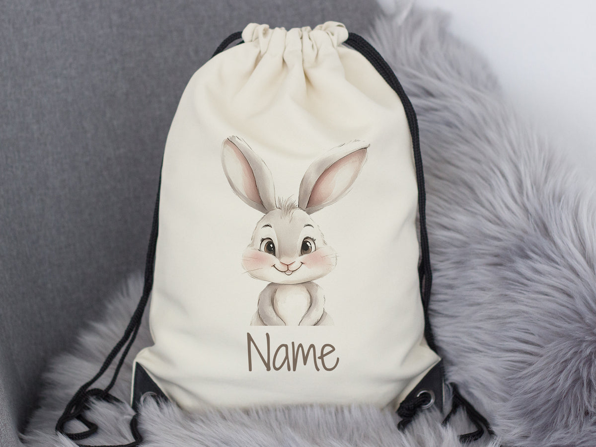 Beige Turnbeutel mit niedlichem Hasenmotiv und Name.