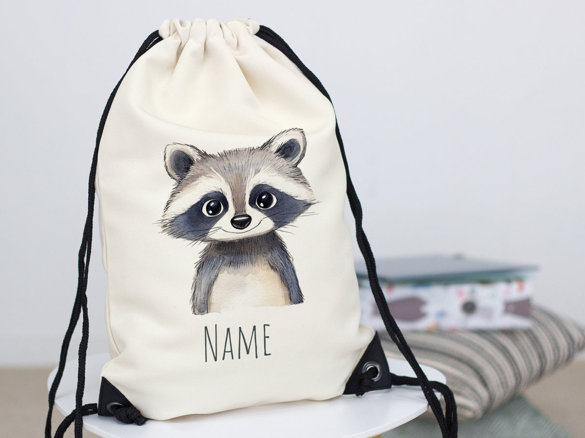 Beiger Rucksack mit Waschbär-Motiv und personalisierbarem Namen.