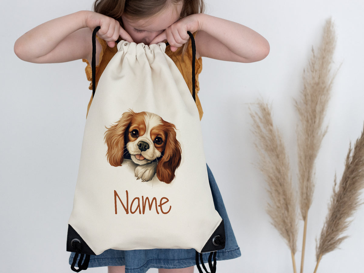 Beige Turnbeutel mit Hundemotiv und personalisiertem Namen.
