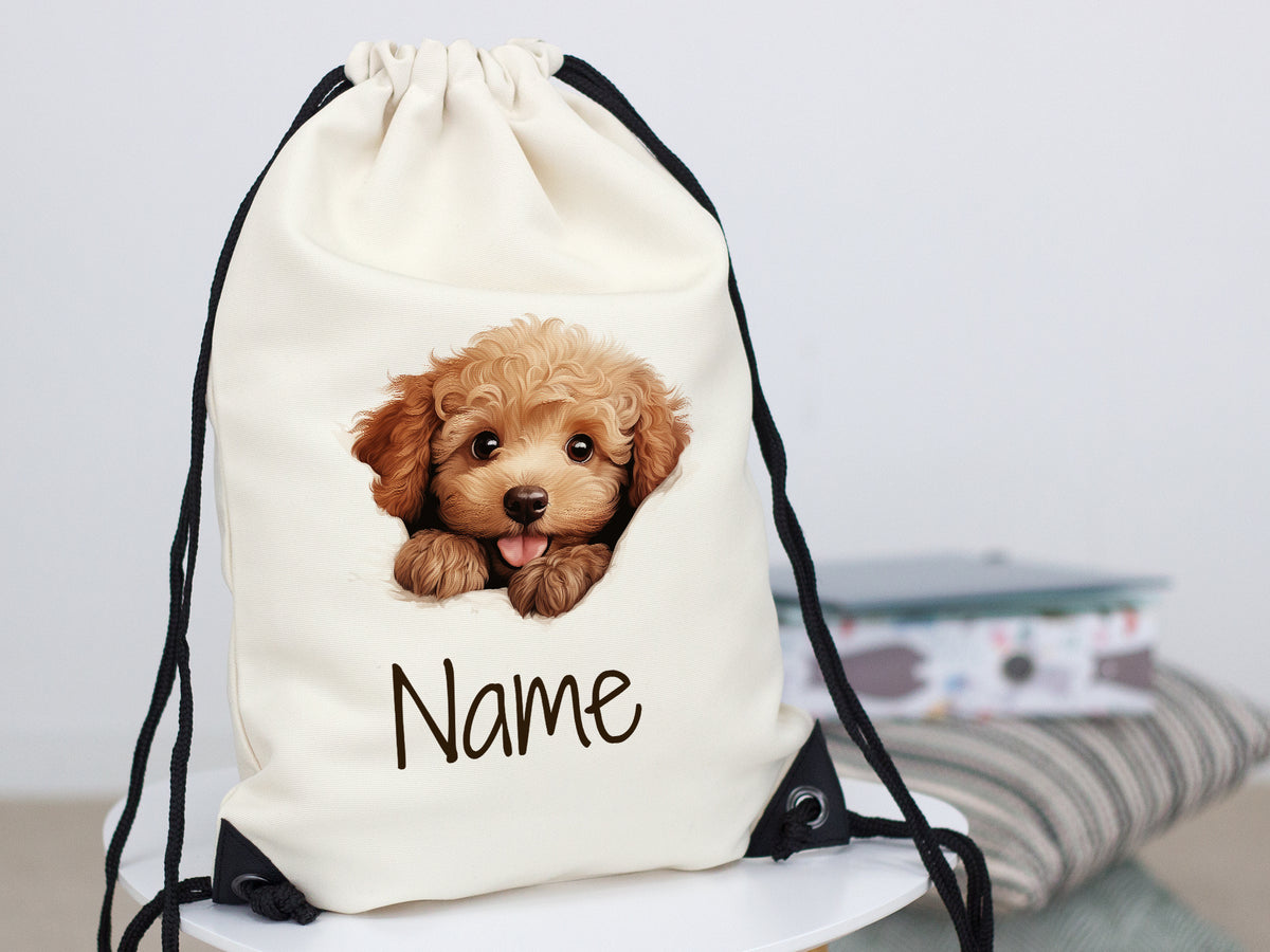 Beige Turnbeutel mit Hundemotiv und personalisierbarem Namen.