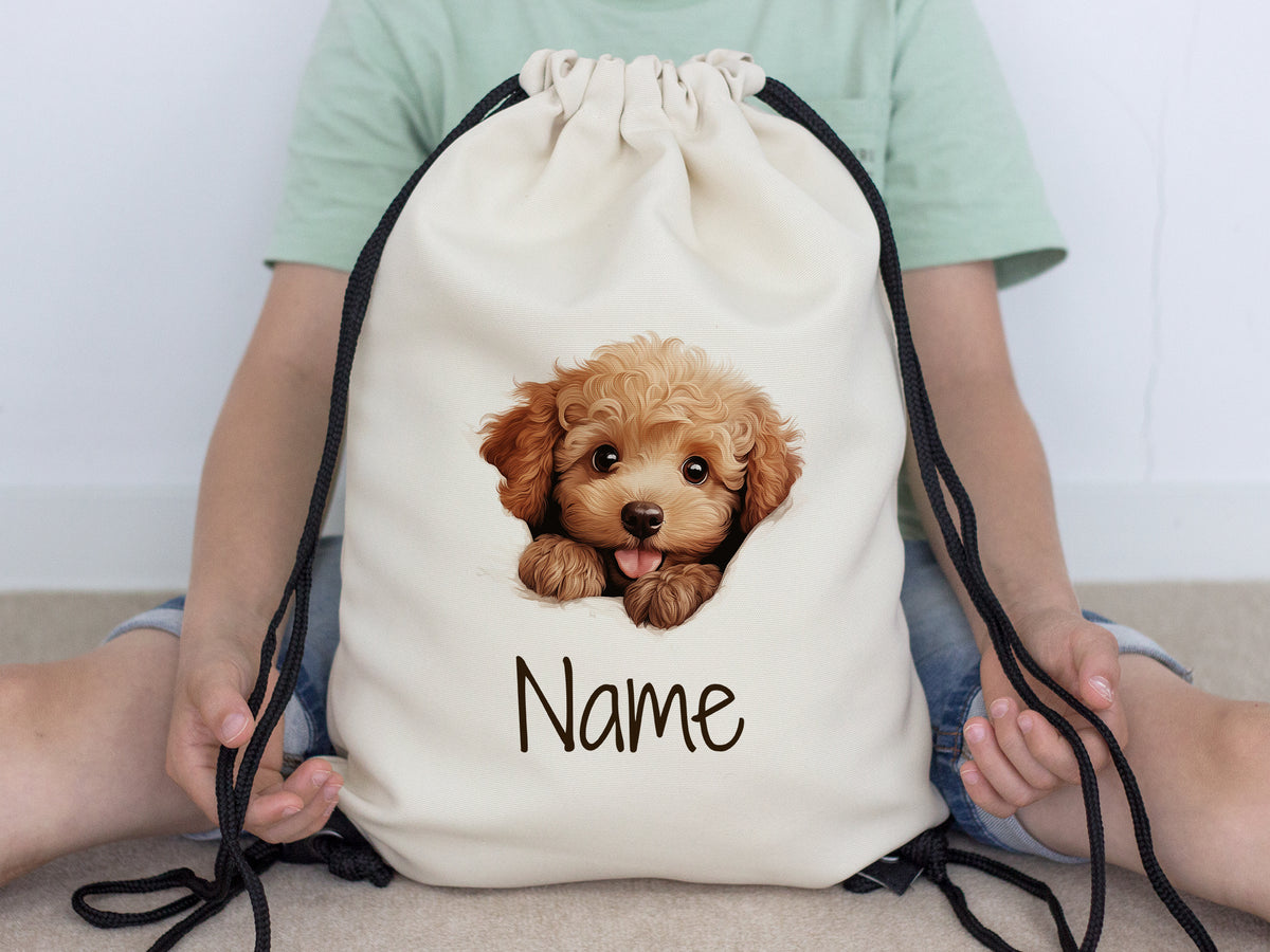 Beige Rucksack mit Hundemotiv und personalisierbarem Namen.