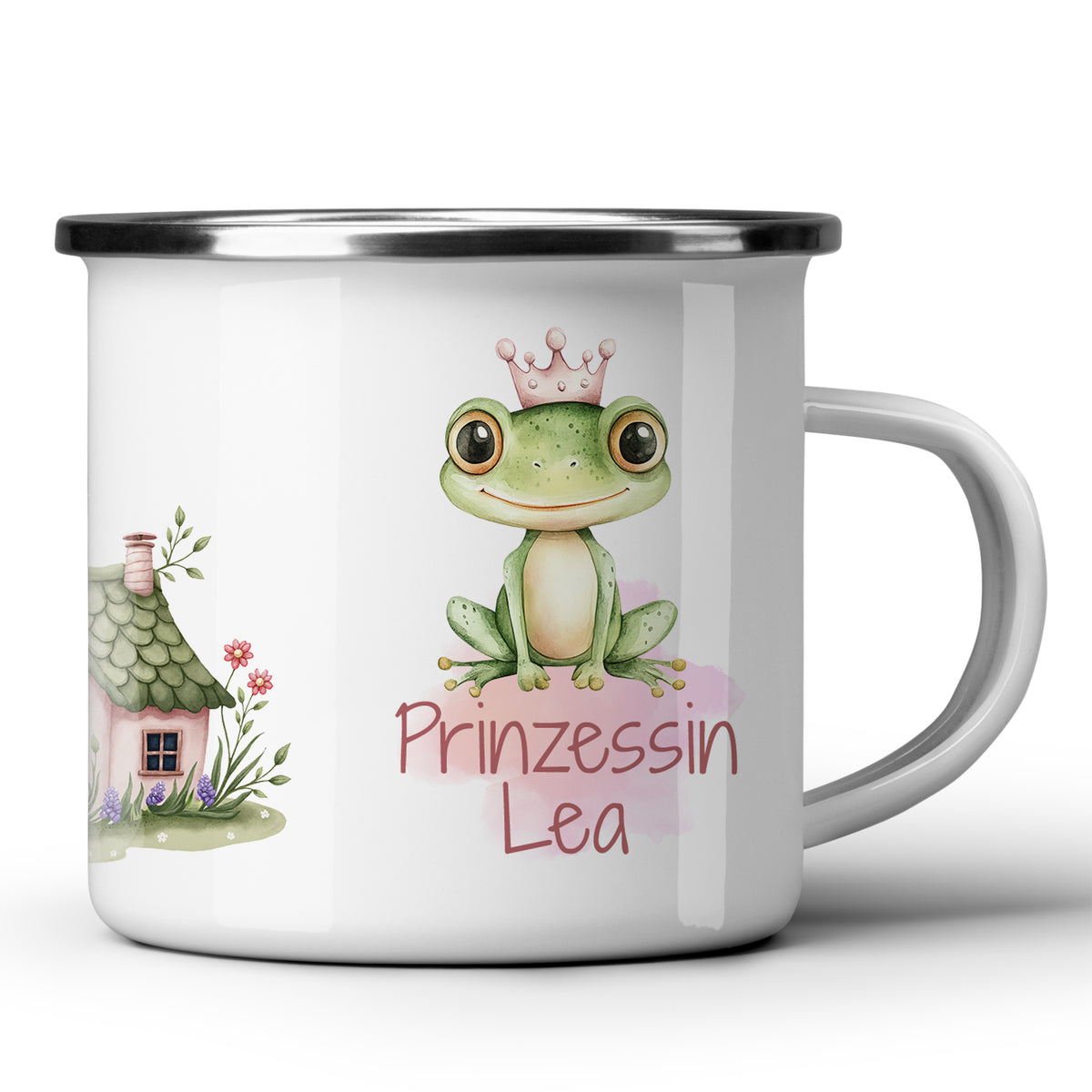 Weißer Emaillebecher mit Frosch und Hausmotiven.