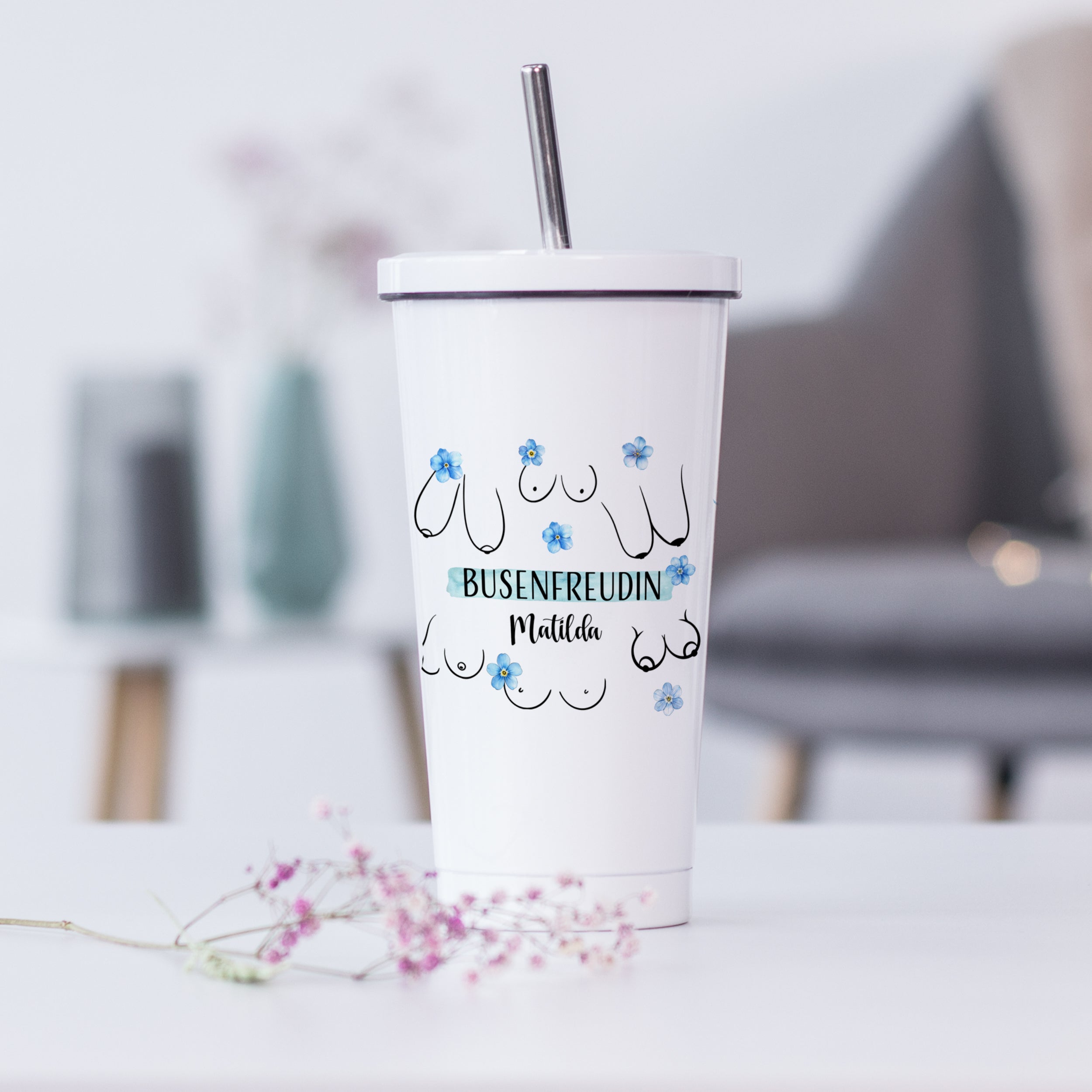 Weißer Becher mit "Busenfreudin Matilda" und Blumen.