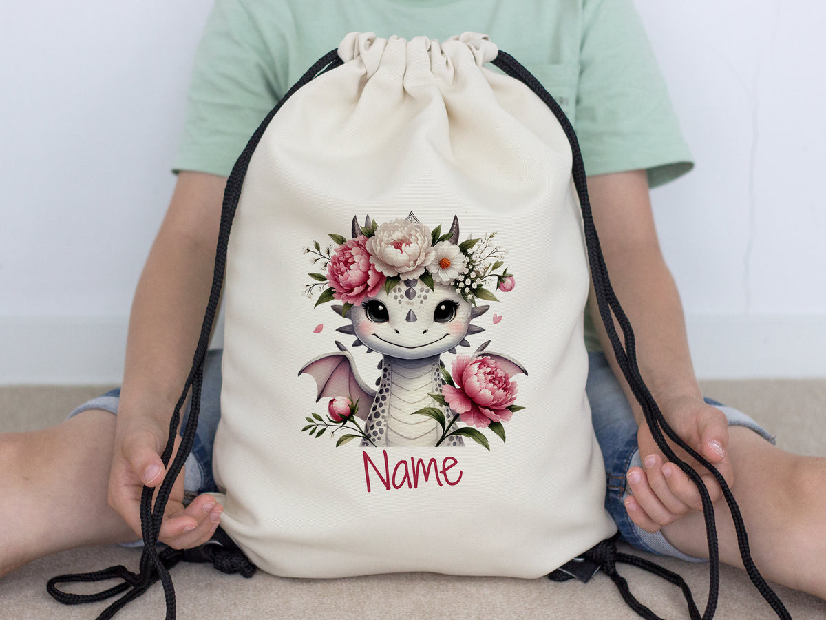Beiger Rucksack mit Drachenmotiv und Blumen.