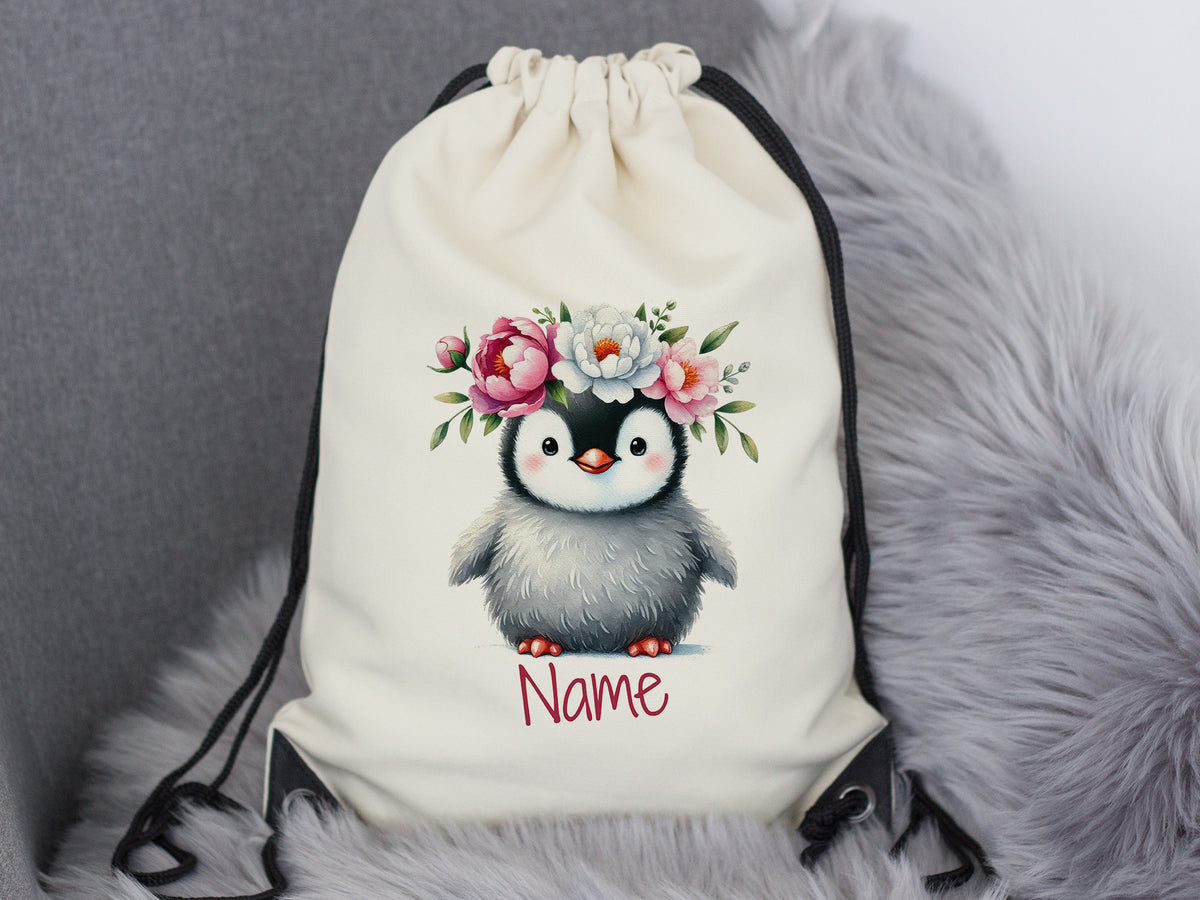 Beiger Rucksack mit niedlichem Pinguin und Blumenkranz.