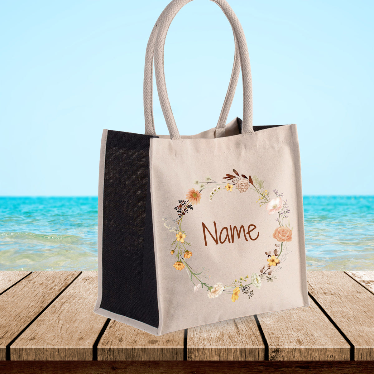Beige Stofftasche mit floraler Stickerei und personalisiertem Namen.