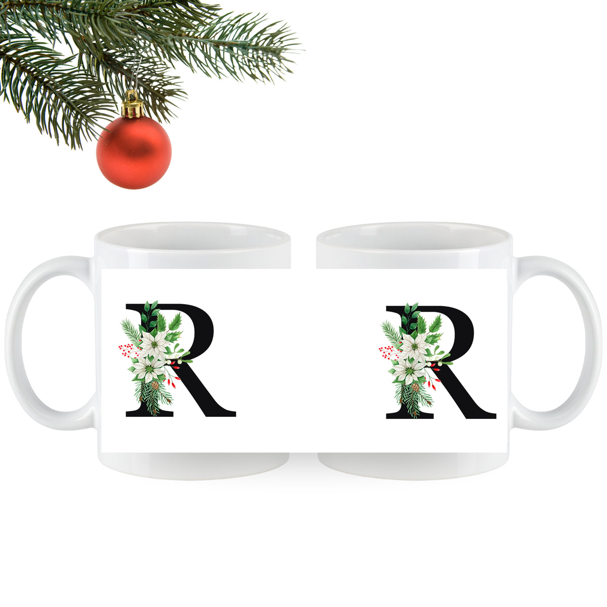 Weiße Tasse mit floralem R-Design und Weihnachtsbaumkugel.