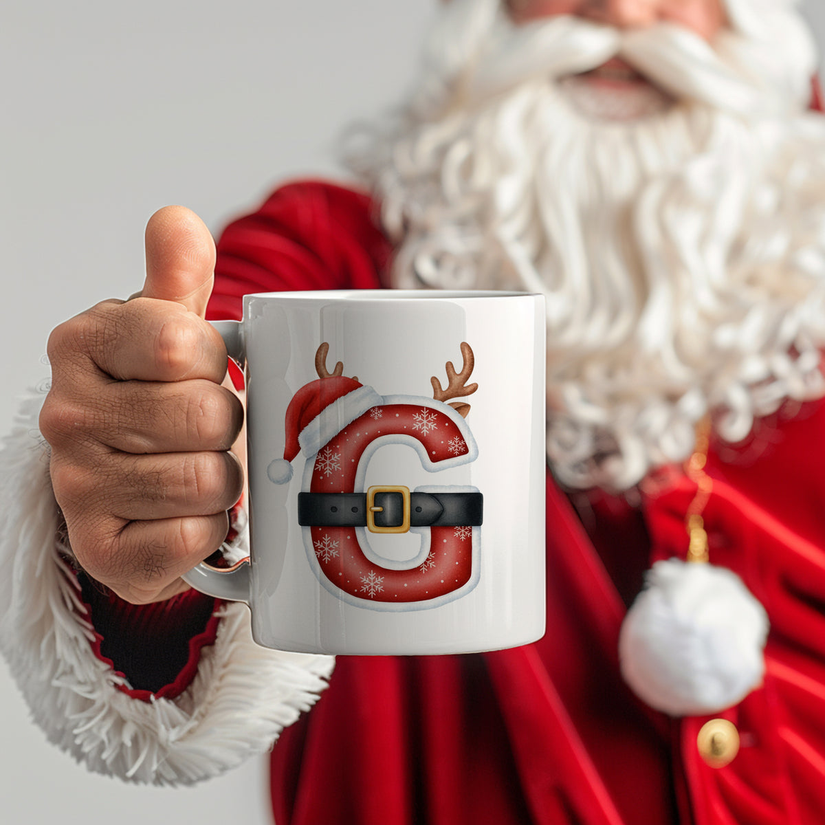 Weißer Becher mit rotem Weihnachtsdesign und Buchstaben "C".