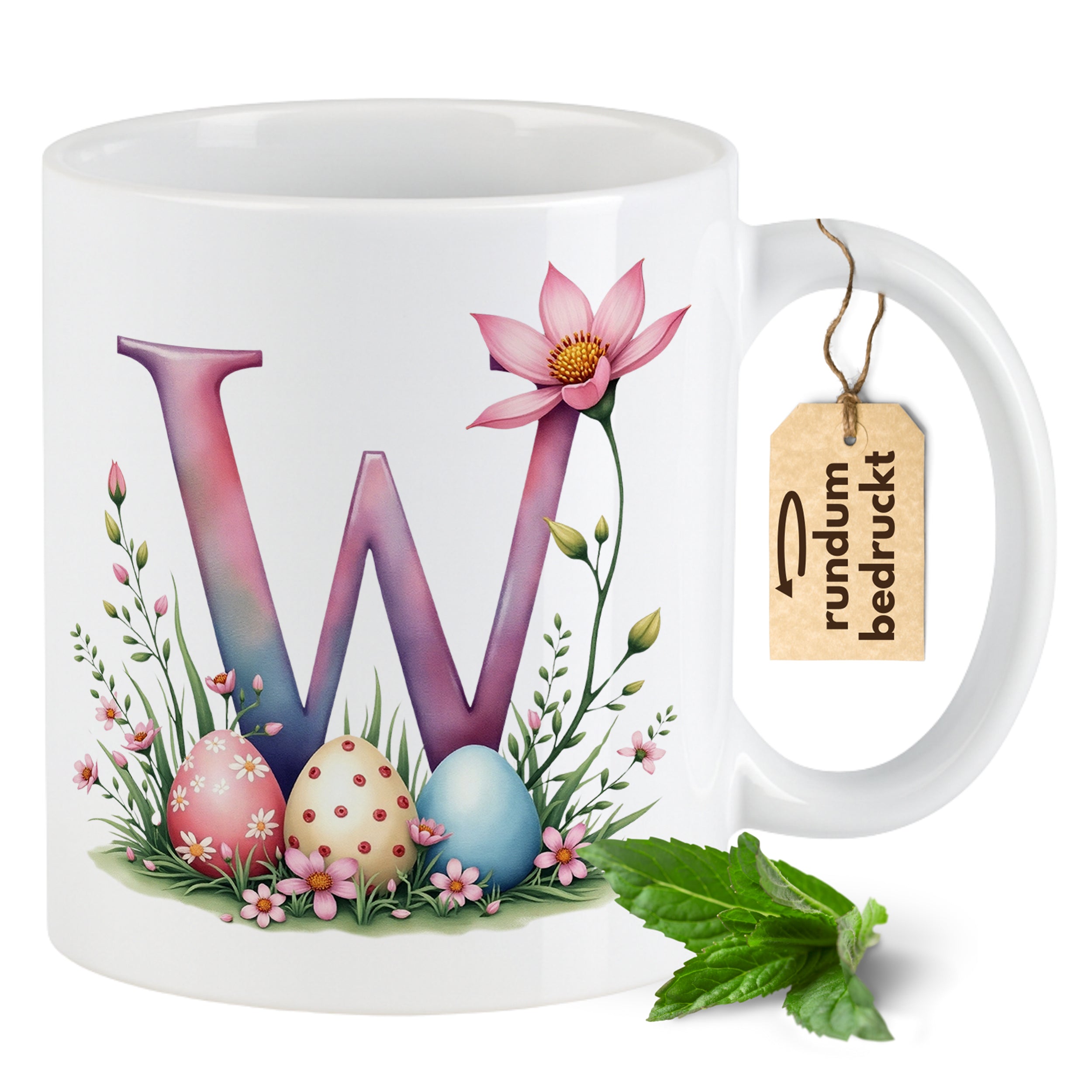 Bunte Tasse mit floralem W, Ostereiern und Blüten.