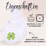 Weißes Lätzchen mit vierblättrigem Kleeblatt-Motiv.